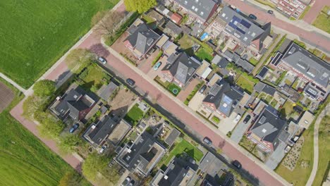 top down aerial of beautiful suburban neighborhood with solar panels on rooftop