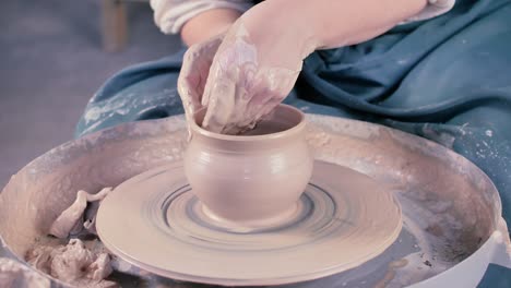 potter's hands shaping up the terracotta pot