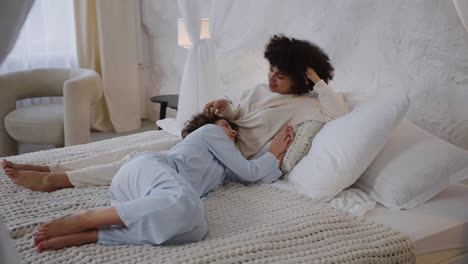 happy couple talking on bed