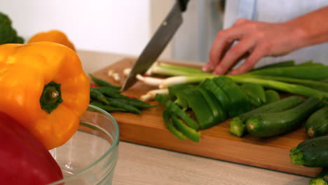 woman slicing green onions