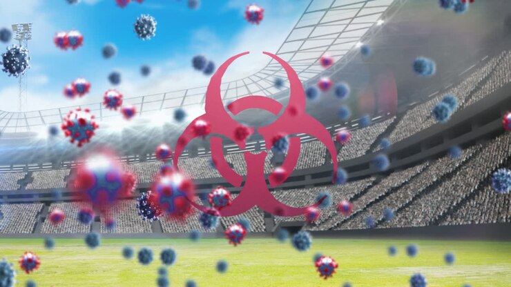 Bio hazard symbol and Covid-19 cells against empty sports stadium