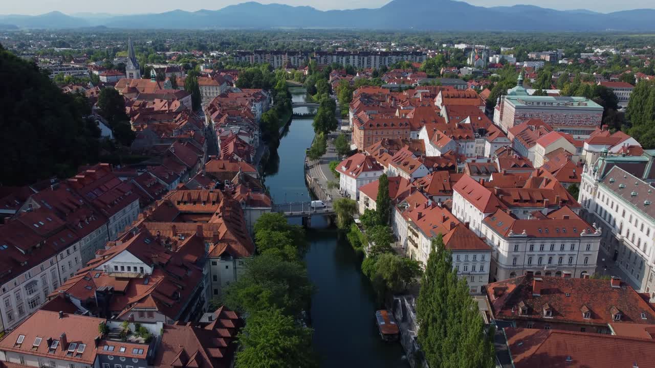 Cinematic Drone Aerial view of Ljubljana Old Town and Ljublanica River on bright summer morning