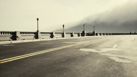 illuminated empty road bridge in a fog