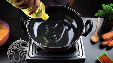 chef add oil to the hot cooking pan for frying chicken lollipop and prepare spicy non vegetarian food