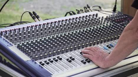 sound mixer and hands at live concert, closeup slowmo