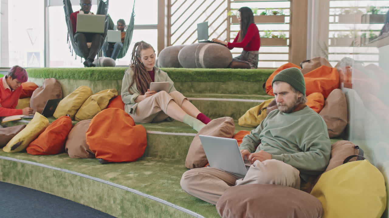 Men and Women Working on Laptops on Modern Office