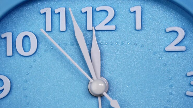Blue wall clock shows the slowly of time.
