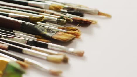 video of diverse brushes lying on white surface