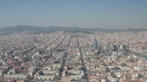 Aerial-panoramic-view-of-large-city.-Tall-landmarks-towering-above-other-town-development.-Barcelona,-Spain