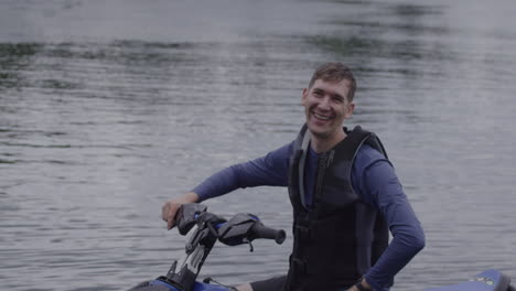 dad waving and smiling on a jet ski