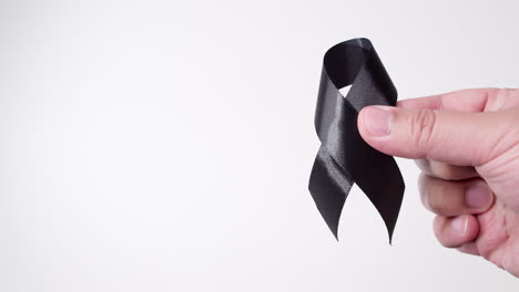 black awareness ribbon on gray background