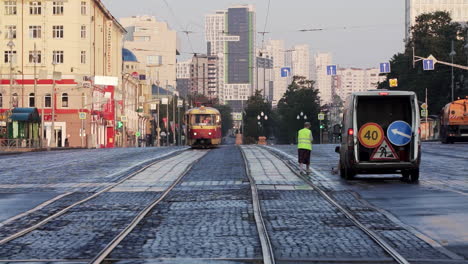 city street scene with tram and worker