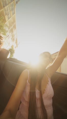 woman in a convertible car in the city