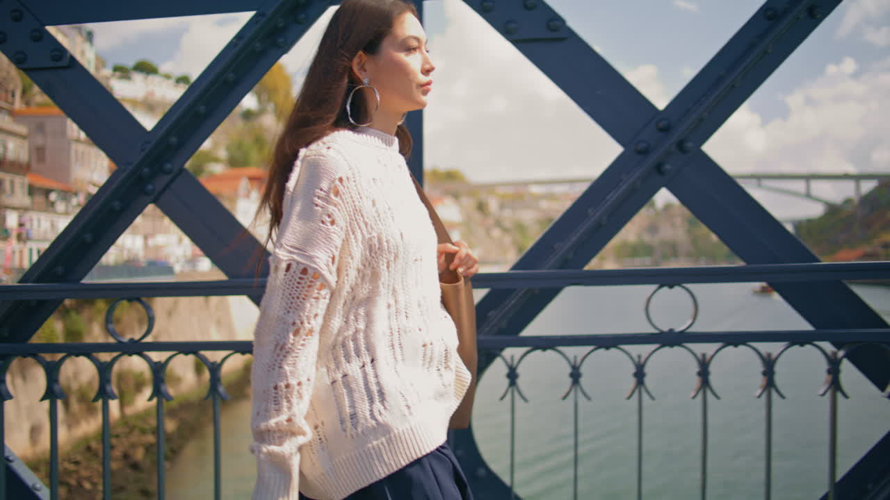 Confident woman crossing bridge smiling on summer walk closeup. Girl strolling