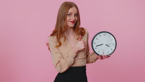 businesswoman girl showing time on office clock ok thumb up approve pointing finger at camera