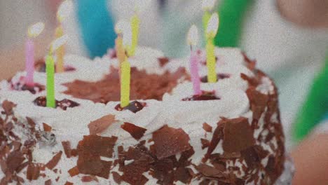 animation of birthday cake with multicolored candles on stand with plates and decoration on table