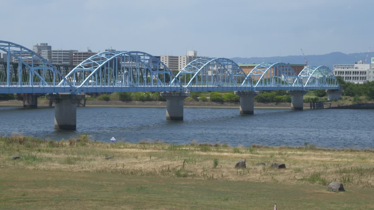 Aqueduct Bridge Carrying Water Pipes Over The Yodo River In Osaka, Japan. - wide shot