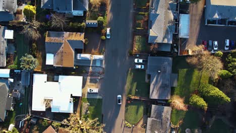 4k aerial birds eye drone shot following moving car on main road