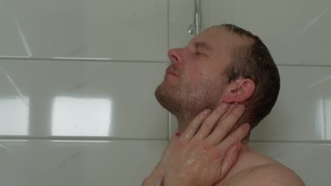 tired man finds solace under the shower's soothing stream