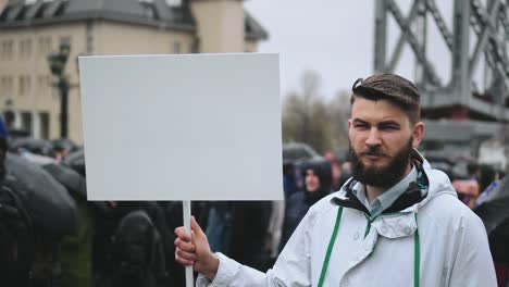 sad man on funeral holds blank advertising copyspace card board banner for text.