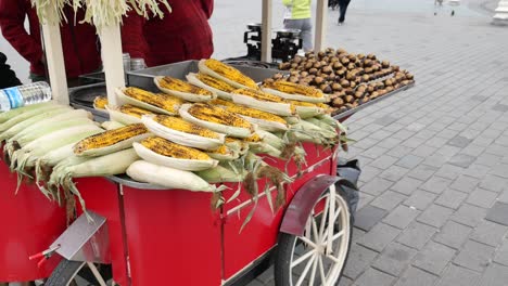 street food cart selling roasted corn and chestnuts