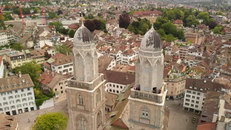 Aerial-drone-shot-circling-above-Grossmünster-in-Zürich-Switzerland