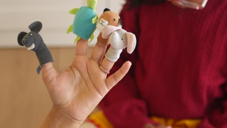 child playing with finger puppets