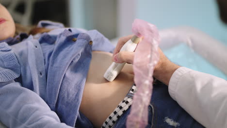 medical professional performing an abdominal ultrasound on a patient