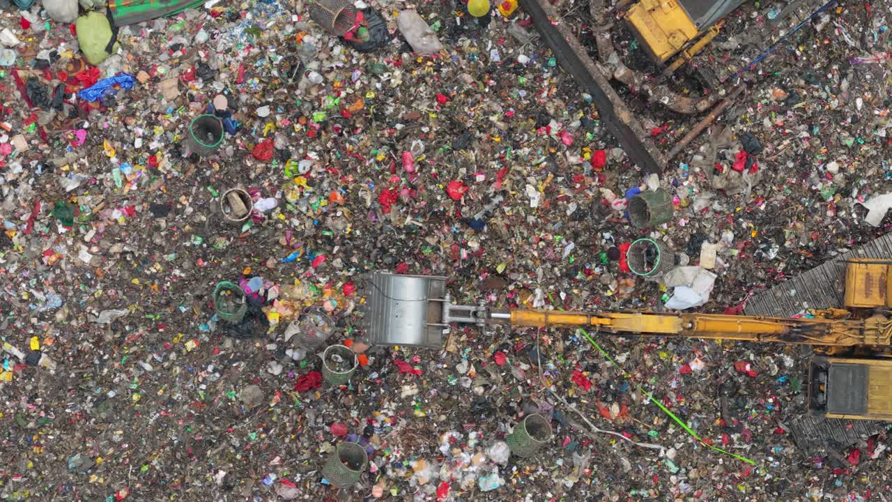 Aerial view of bantar gebang landfill with excavators and scavengers