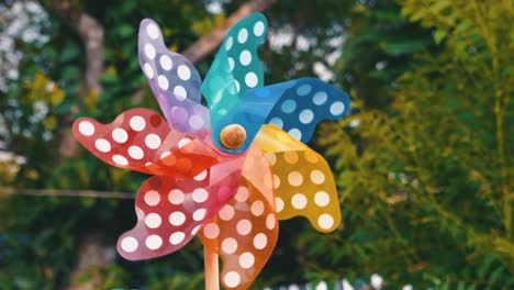 toy turbine rotate in wind blowing with green nature background