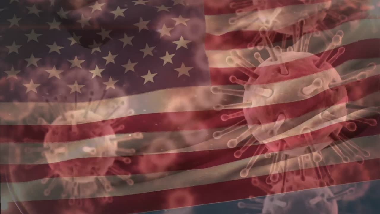 움직이는 미국 국기 위에 퍼지는 거대 코로나바이러스 코로나19 세포의 애니메이션