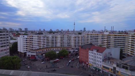 Stunning-aerial-top-view-flight-City-Berlin-suburban-railroad-station-prefabricated-building-skyscrapers-district-Neukoeln,-Germany-Summer-day-2023