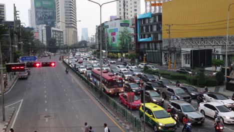 ambulance with flashing lights in busy city traffic