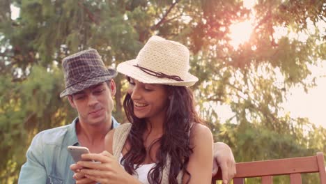 Cute-couple-doing-selfie-in-the-park