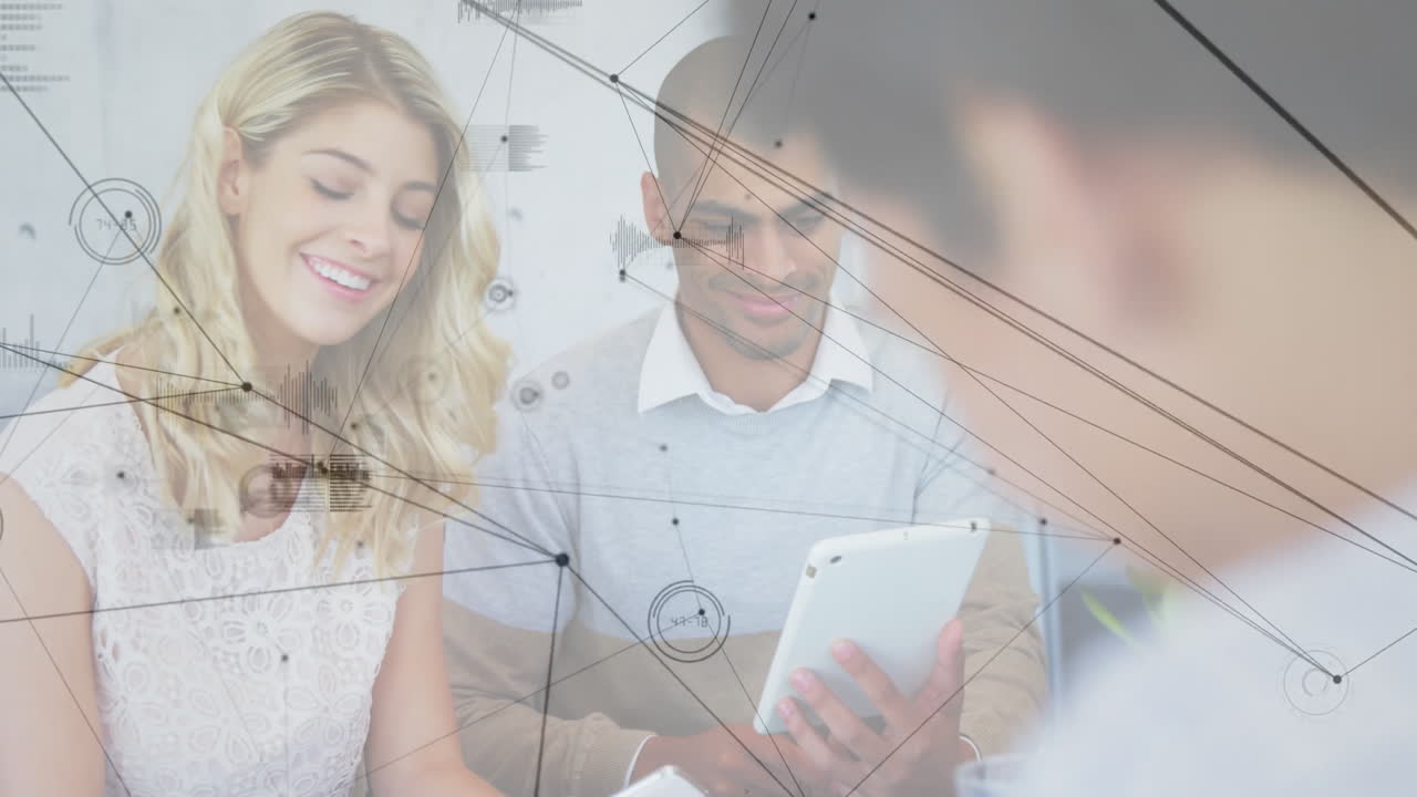 Using tablet, colleagues discussing network connections and data processing overlay