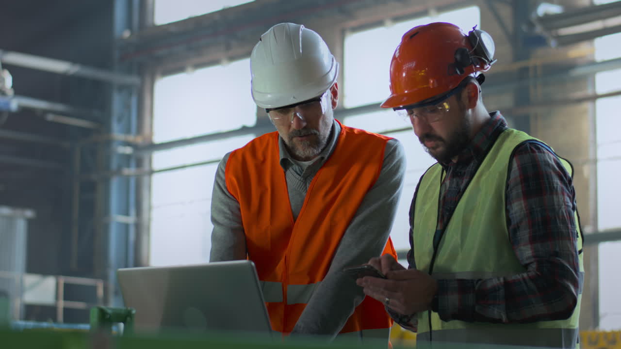 Factory Engineers Reviewing Project on Laptop