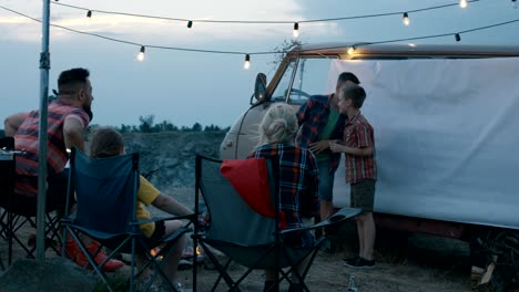 people with children playing charades in campsite