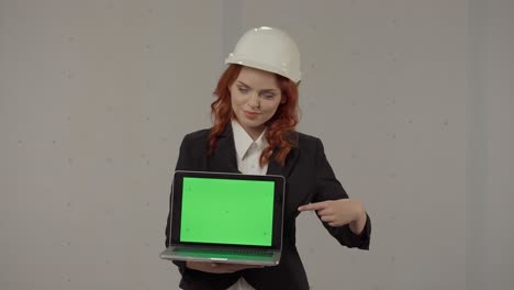 woman engineer presenting laptop with green screen
