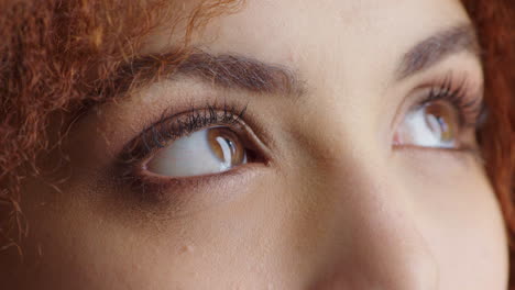 closeup of a woman staring up