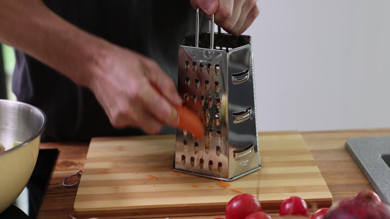 Grating carrots in the kitchen