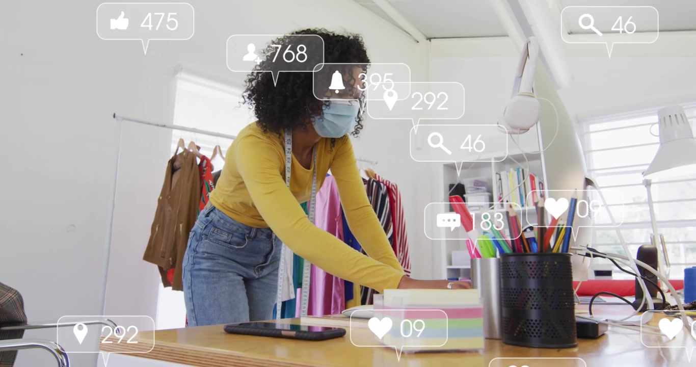 Animation of media icons over african american businesswoman in office