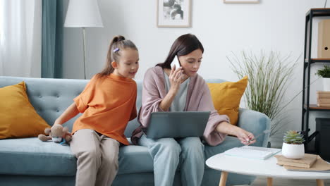 working mom with a playful child at home
