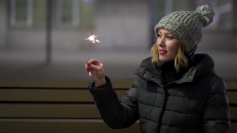 woman with sparkler at night