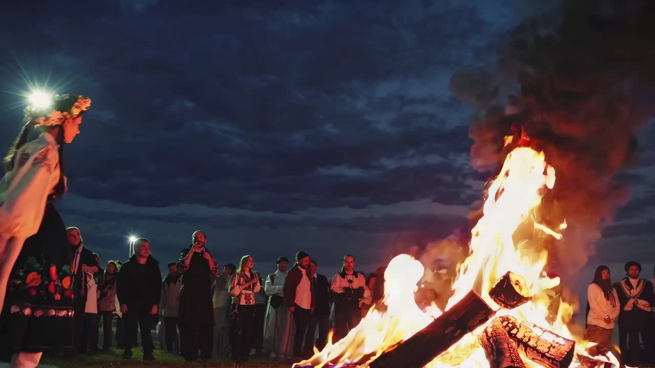 Folk Dance Performance by Women near Bonfire at Night