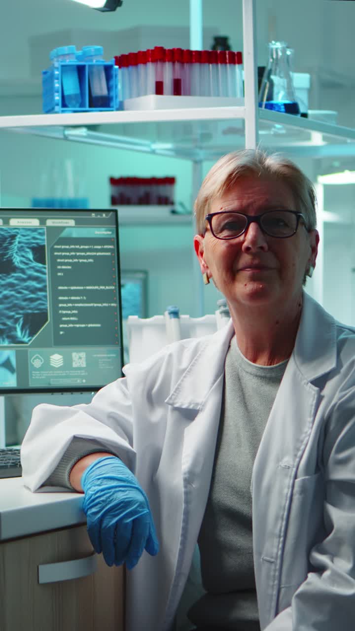 Vertical video: Portrait of senior scientist woman looking exhausted at camera