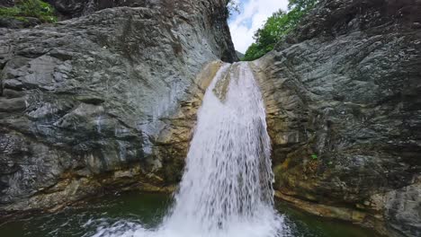 dynamic cinematic fpv flight along tropical rainforest creek and waterfall