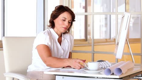 Businesswoman-working-at-her-desk