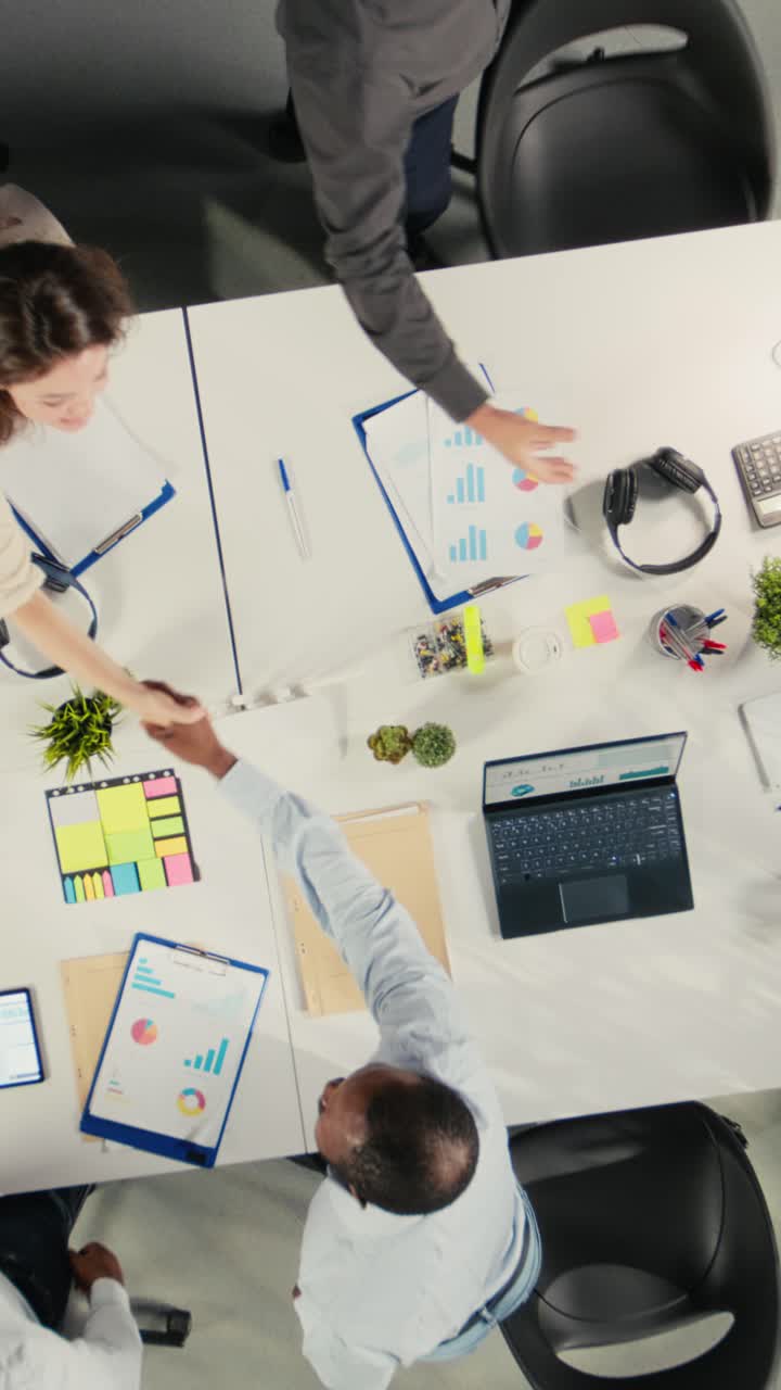 Vertical Video Top down view zoom in of company staff engaged in a corporate event