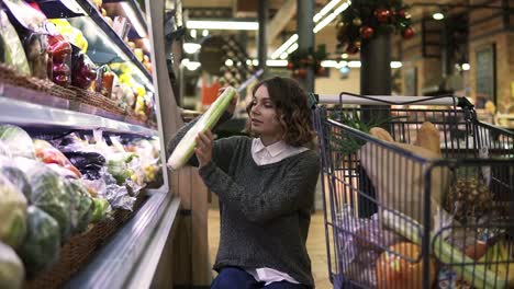 Junge-Frau-Im-Modernen-Supermarkt-Wählt-Sellerie-Lauch-In-Der-Bio-Gemüseabteilung.-Gesunde-Frau,-Die-Grüne-Lebensmittel-Kauft