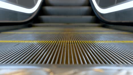 close-up 4k motion of moving empty escalator staircase running up